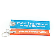 Charger l'image dans la galerie, 2 porte-clés flamme Aviation Sans Frontières "REMOVE BEFORE FLIGHT"